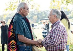 Chief Arvol Looking Horse and Methodist Bishop Bruce Ough visit the Red Rock, a boulder that is located at a United Methodist Church in Newport, Minnesota, and considered sacred by the Dakota people. The 2017 Forum included site visits addressing local peace-building topics.